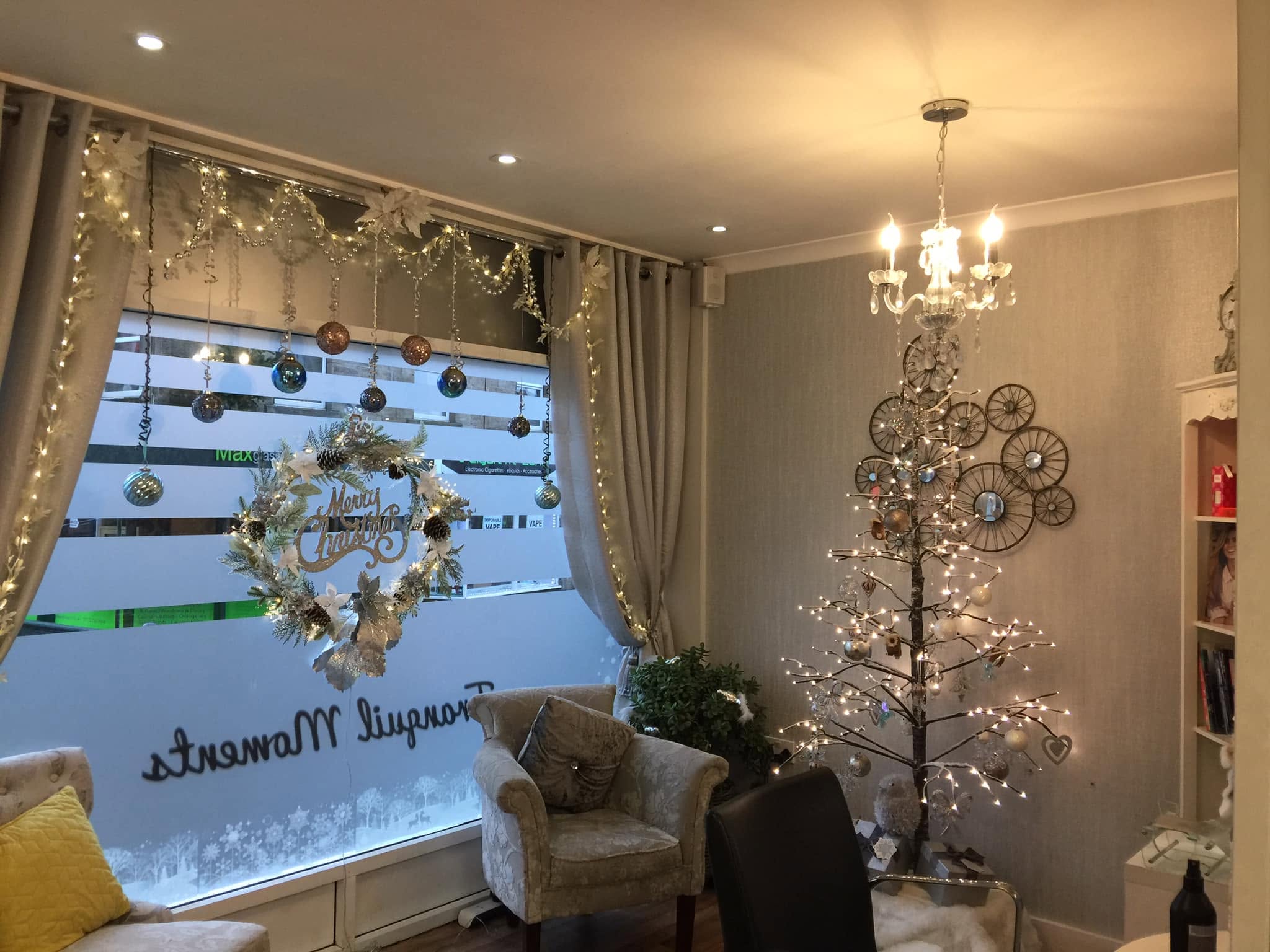 The salon’s window seating, chandelier and seasonal decorations